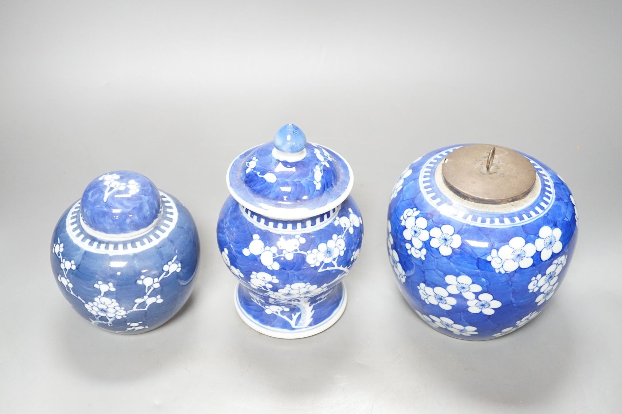 Three Chinese blue and white prunus decorated jars and covers, 19th/20th century, with four character marks 18cm